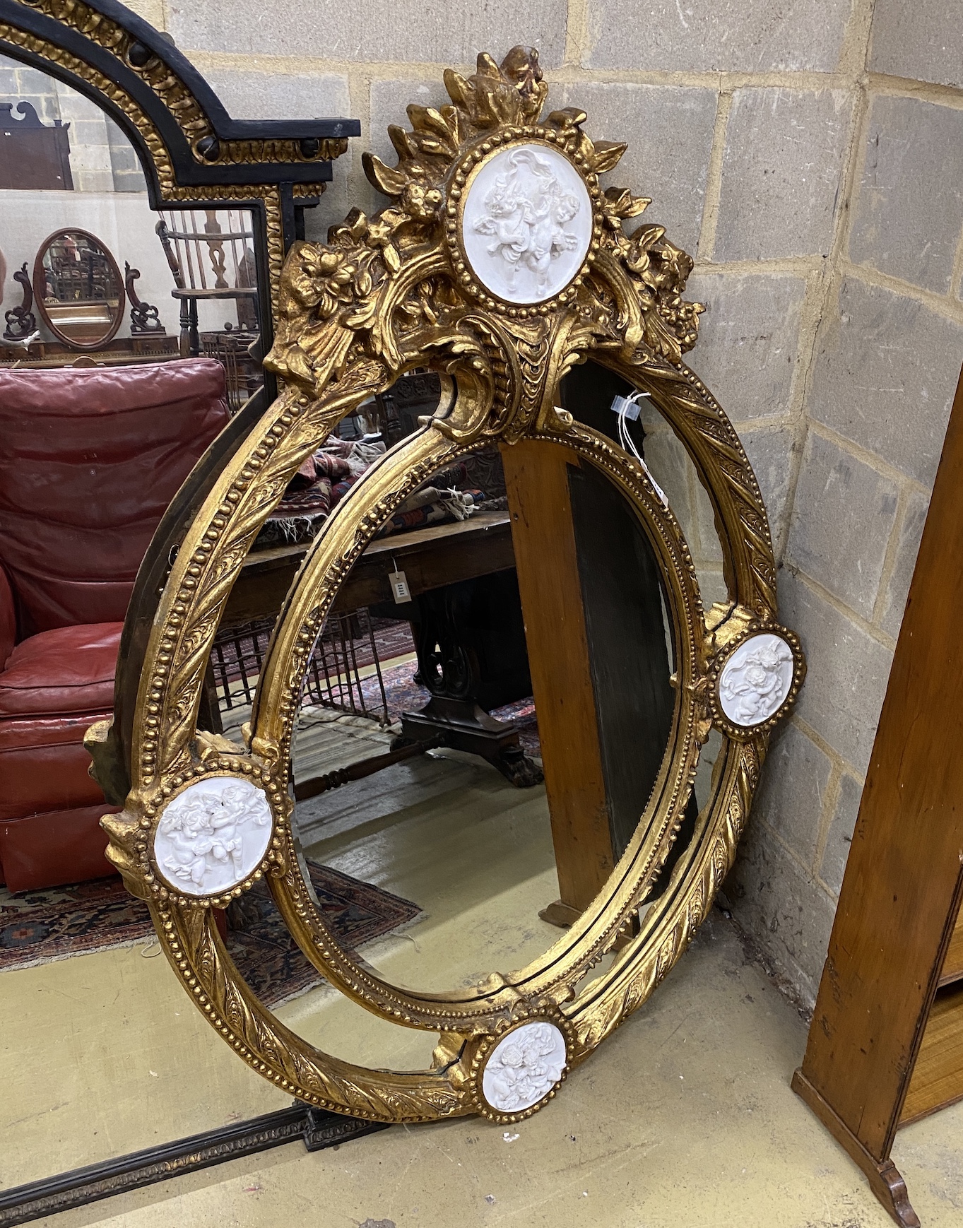 A Victorian style gilt composition and faux marble wall mirror, width 100cm, height 144cm